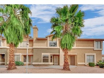 Inviting multi-Gathering home featuring stucco siding and desert landscaping, complemented by mature palm trees and a blue sky at 3891 Terrazzo Ave, Las Vegas, NV 89115
