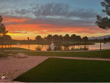 Scenic backyard view overlooking a lake and golf course at sunset at 5130 Agio Ave, Pahrump, NV 89061