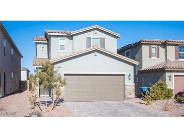 Two-story house with attached garage and landscaped front yard at 6586 Rustic Saddle Ct, Las Vegas, NV 89141