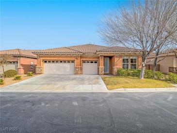 Single-story house with three-car garage and desert landscaping at 10840 Villa Torre St, Las Vegas, NV 89141