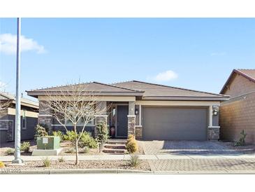 Single-story home with stone accents and a two-car garage at 1170 N Water St, Henderson, NV 89011