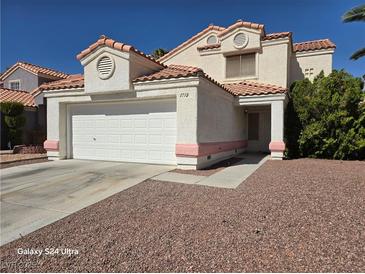 Two-story house with attached garage and landscaped yard at 1732 Monte Alban Dr, North Las Vegas, NV 89031