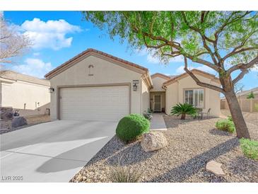 Single-story house with a two-car garage and landscaped front yard at 2525 Shore Bird Ave, North Las Vegas, NV 89084