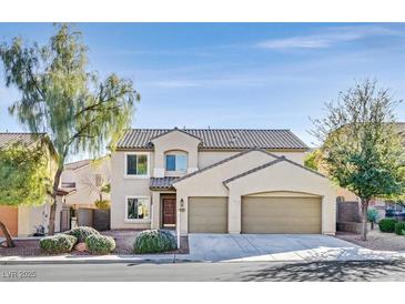 Two-story house with attached two-car garage and landscaping at 33 Gentilly Lace Ave, Henderson, NV 89002