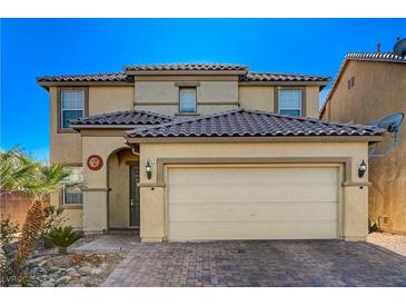 Two-story house with tan siding, brown roof, and a two-car garage at 3517 Colby Creek Ave, North Las Vegas, NV 89081