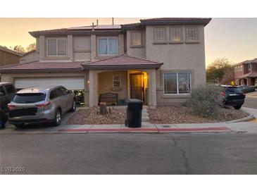 Two-story house with attached garage and landscaping at 5345 Tustin Hills St, North Las Vegas, NV 89081