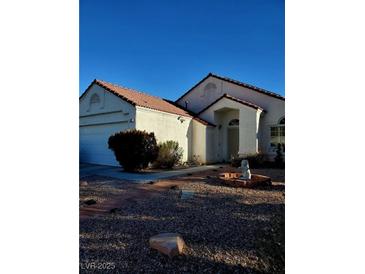 Single-story house with a terracotta tile roof and landscaped front yard at 637 Bay Bridge Dr, North Las Vegas, NV 89032