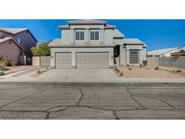 Two-story house with three-car garage and landscaped front yard at 7900 Holly Knoll Ave, Las Vegas, NV 89129