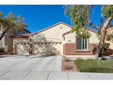 House exterior boasts a two-car garage and well-manicured landscaping at 968 Mill Run Creek Ave, Henderson, NV 89002