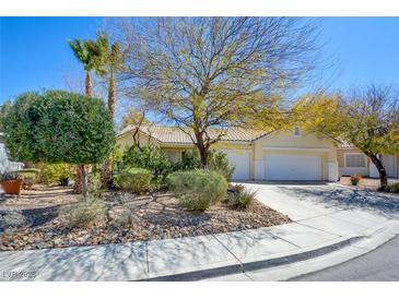 Charming single-story home with a well-manicured front yard and a three-car garage at 1140 Woodcastle St, Henderson, NV 89052