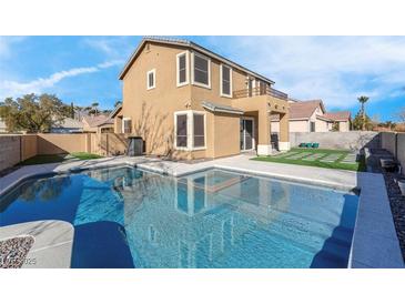 Two-story house with a refreshing blue swimming pool in the backyard at 1736 Hill Canyon Ln, Las Vegas, NV 89144