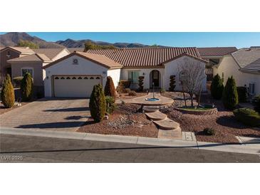 Charming single-story home showcasing a well-maintained yard, stone accents, and a two-car garage at 2204 Twin Falls Dr, Henderson, NV 89044