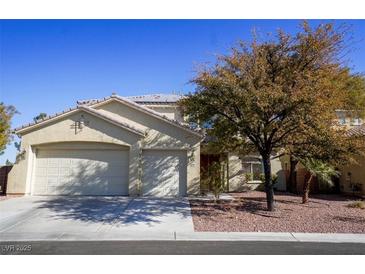 Two-story house with a three-car garage and landscaped front yard at 10500 Eagle Nest St, Las Vegas, NV 89141