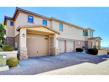 Two-story home with attached garage and paved driveway at 1323 Red Baron Ln, Boulder City, NV 89005