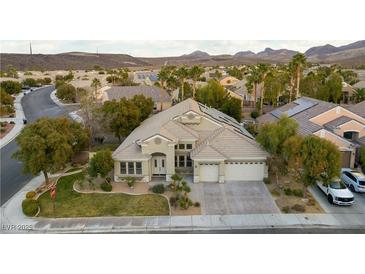 Stunning aerial view of a single-story house with a landscaped yard and a two-car garage at 1350 Rossini St, Henderson, NV 89052