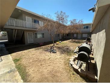 Apartment complex courtyard with BBQ grills and small play area at 212 Orland St # 26, Las Vegas, NV 89107