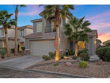 Two-story house with gray siding, palm trees, and a well-manicured front yard at 2465 Sturrock Dr, Henderson, NV 89044