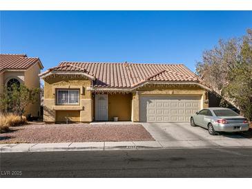 Single-story house with a two-car garage and desert landscaping at 2535 River Oaks Dr, Las Vegas, NV 89156