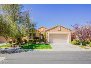 Single-story home with a two-car garage and well-manicured lawn at 36 Hunt Valley Trl, Henderson, NV 89052