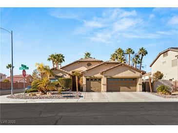 Single-story home with a three-car garage and desert landscaping at 3801 Terrace Grove St, Las Vegas, NV 89129