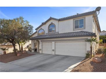 Charming two-story home featuring a three-car garage, desert landscaping, and neutral-colored stucco exterior at 41 Voltaire Ave, Henderson, NV 89002