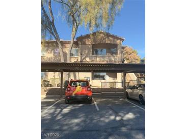 Condo complex with covered parking and building exterior at 5751 E Hacienda Ave # 244, Las Vegas, NV 89122