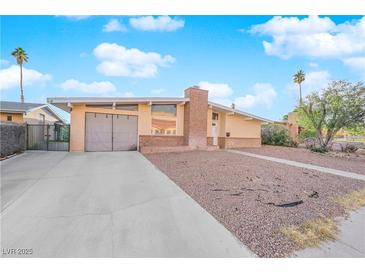 Ranch style home with attached garage and landscaped yard at 6205 Hargrove Ave, Las Vegas, NV 89107