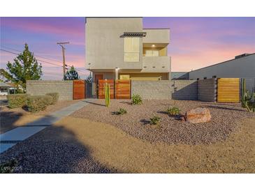 Modern two-story home with a landscaped front yard and wood gate at 1303 S 8Th St, Las Vegas, NV 89104