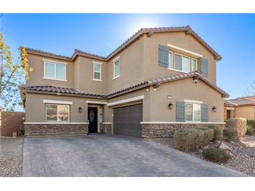 Two-story house with gray shutters, stone accents, and a paved driveway at 1413 Fantastic Ct, North Las Vegas, NV 89081