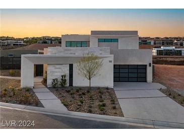 Modern two-story home with attached garage and landscaped front yard at 168 Still Shores St, Henderson, NV 89011