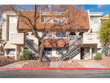 Attractive exterior of a two-story building with tiled roofs and stairs at 3585 Arville St # 402C, Las Vegas, NV 89103