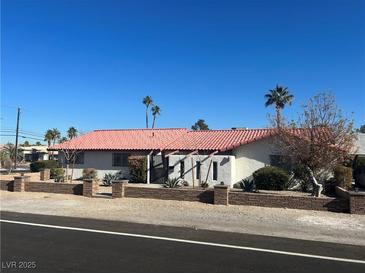 Single-story home with red tile roof and landscaped yard at 7075 Del Rey Ave, Las Vegas, NV 89117