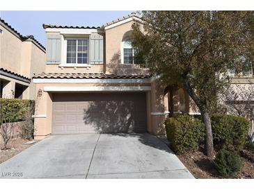 Two-story house with attached garage and landscaping at 10264 Headrick Dr, Las Vegas, NV 89166