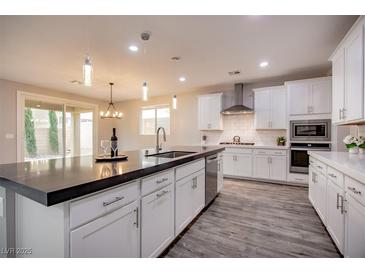 Modern kitchen with white cabinets, stainless steel appliances, and a large island at 10823 Crestview Pointe Ave, Las Vegas, NV 89166