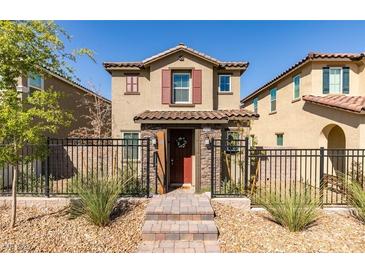 Two-story house with red door and landscaped yard, featuring a modern design at 2509 Piacenza Pl, Henderson, NV 89044