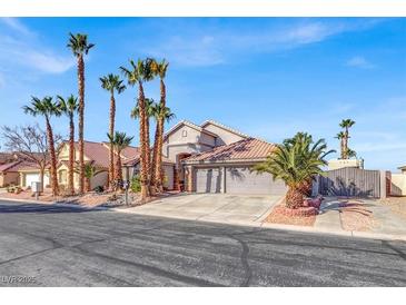 Charming home with a well-maintained yard, palm trees, and a spacious three-car garage at 278 Iron Duke Ave, Las Vegas, NV 89183