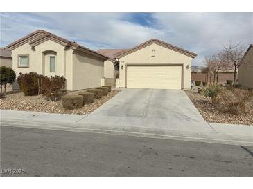 One-story house with attached garage and landscaped front yard at 3310 Fernbird Ln, North Las Vegas, NV 89084