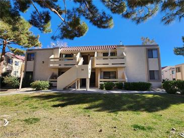 Two-story building with Spanish tile roofs, balconies, and a grassy yard at 3800 Desert Marina Dr # 160, Laughlin, NV 89029