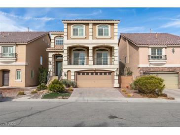 Two-story house with tan exterior, three-car garage, and landscaping at 6050 Belvedere Canyon Ave, Las Vegas, NV 89139