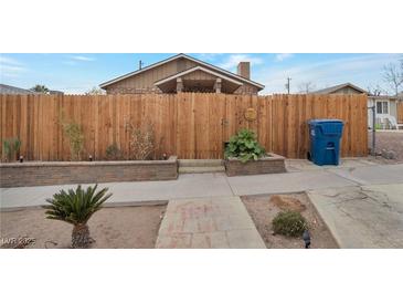 Inviting front yard with wooden fence and stone accents at 628 L, Boulder City, NV 89005