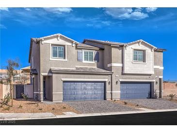 New two-story home with gray exterior, two-car garage, and landscaped front yard at 6546 Coffee Theme St # Lot 11, North Las Vegas, NV 89084