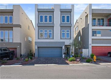 Contemporary two-story home with gray exterior and attached garage at 7777 Tempest Sol Ave, Las Vegas, NV 89113