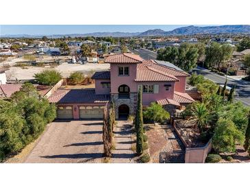 Gorgeous two-story home with a tile roof, three-car garage, and stone accents at 8490 Via De Bellasidra Ct, Las Vegas, NV 89123