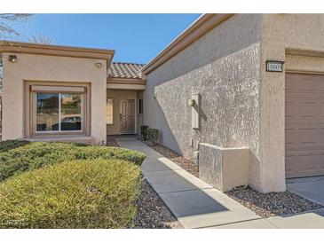 Front view of house with walkway, landscaping, and two-car garage at 10009 Hemet Dr, Las Vegas, NV 89134