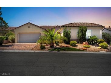 Single-story home with a tile roof, landscaping, and a two-car garage at 1717 Warrington Dr, Henderson, NV 89052