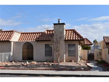 Spanish style home with tile roof, front yard landscaping, and gated entry at 2816 Mohawk St, Las Vegas, NV 89146