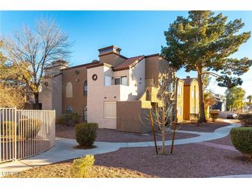 Attractive exterior of a two-story building with landscaping and walkways at 2983 Juniper Hills Blvd # 203, Las Vegas, NV 89142