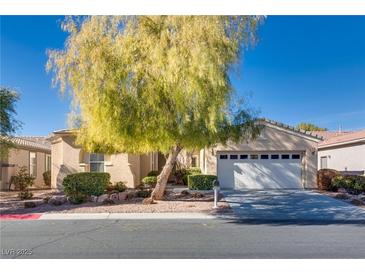 Single-story house with attached garage, mature tree, and landscaped yard at 4705 Bersaglio St, Las Vegas, NV 89135