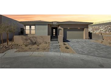 Single-story home with attached garage and landscaped front yard at 4973 Sandline Ct, Las Vegas, NV 89135