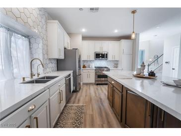 Modern kitchen with stainless steel appliances and quartz countertops at 5992 Genovese Ave, Las Vegas, NV 89141